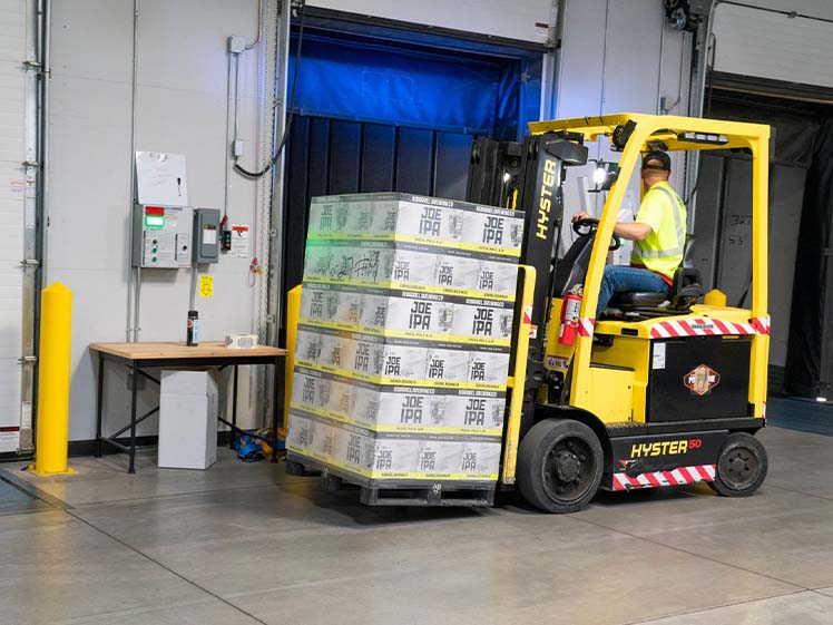 Warehouse Forklift Handling Palletized Freight at Loading Dock