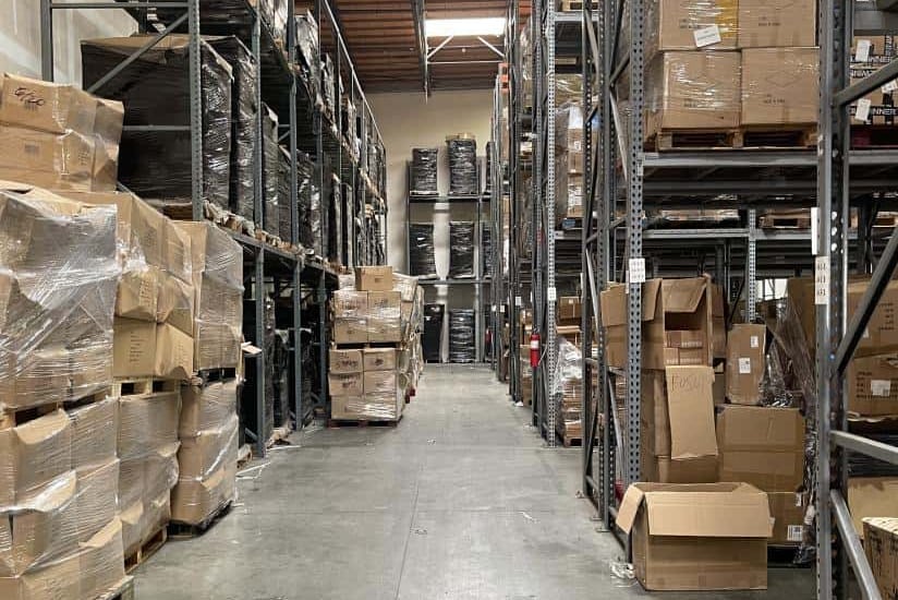Cartons and wrapped pallets stored on racks in a NicheSources USA warehouse