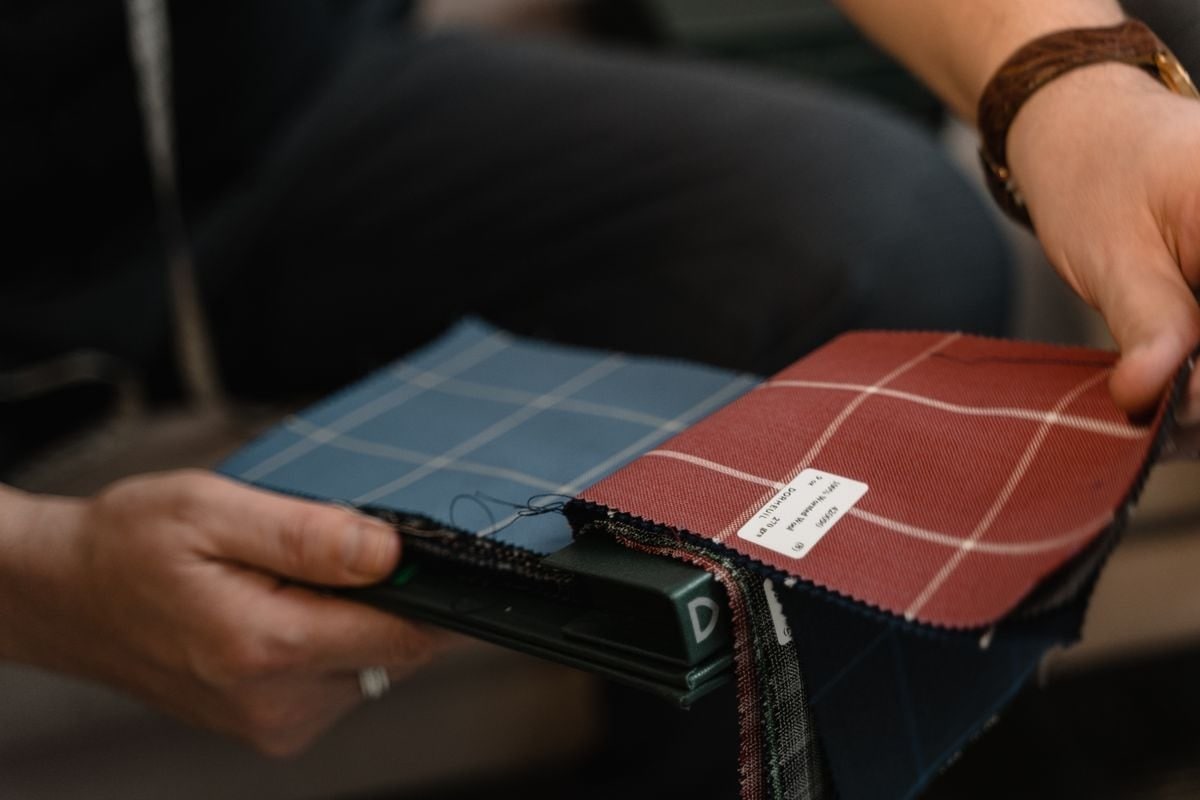 Hands comparing physical fabric swatches